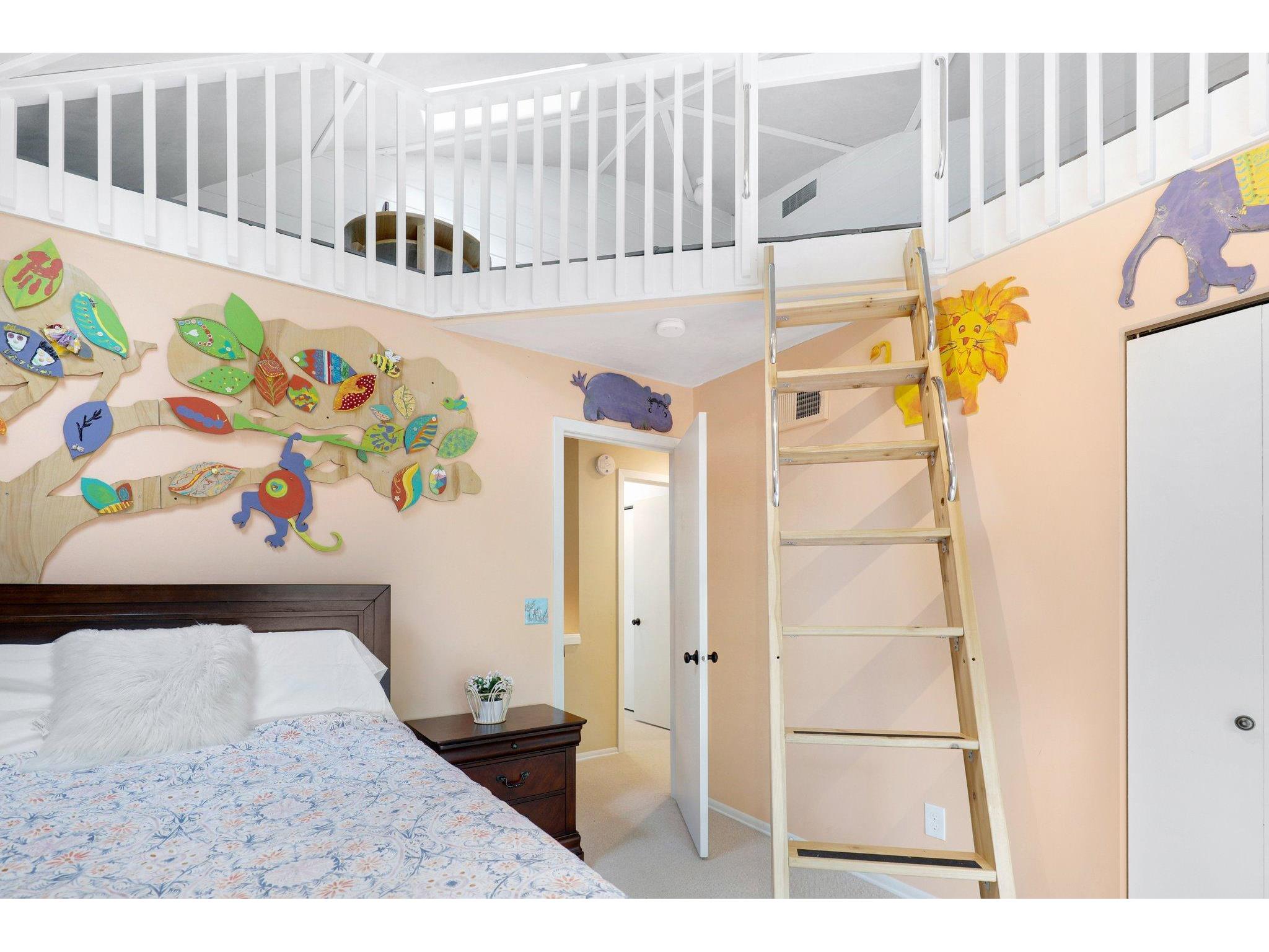 Childrens bedroom with a loft play area