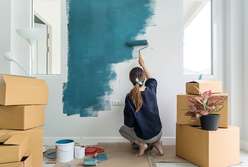 Homeowner painting a wall